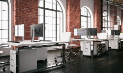 A photograph of an office with desks and computers