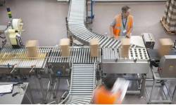 A photograph of two men working in a factory