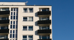 A photograph of a highrise building with blue sky