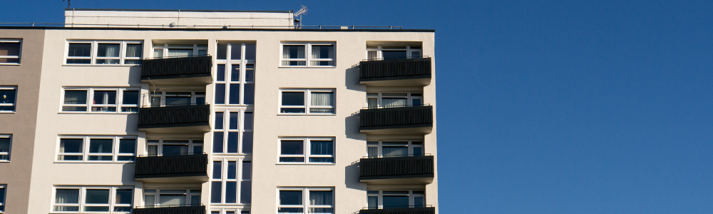 A photograph of a highrise building with blue sky