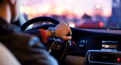 man driving a car wearing wrist watch